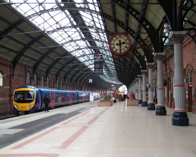 A platform at Darlington train station with a waiting train